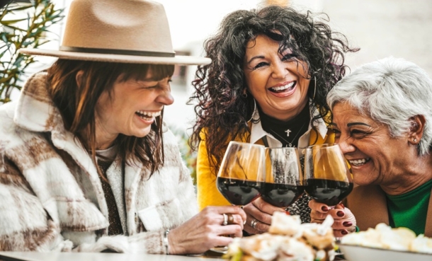 women drinking red wine at bar restaurant