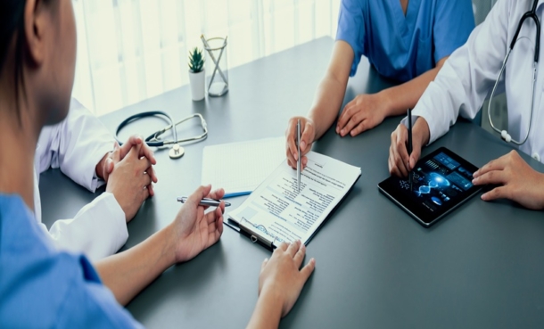 Group of doctor or researcher studying genetic disease with patient