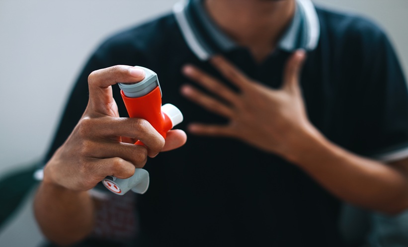 Patient using an inhaler, representing testosterone treatment and respiratory medication use.