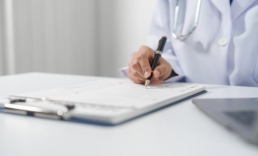 Doctor completing a medical screening questionnaire for leprosy detection.