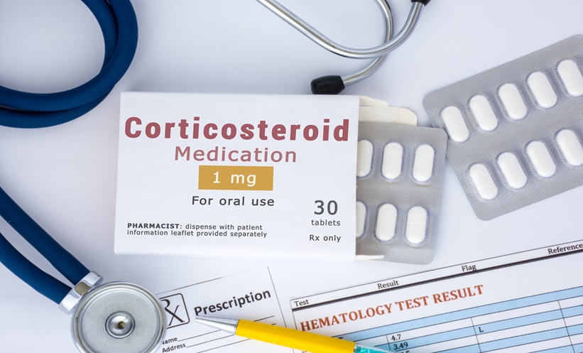 Corticosteroid medication or drug concept photo. On doctor table lies open packaging labeled "Corticosteroid medication"