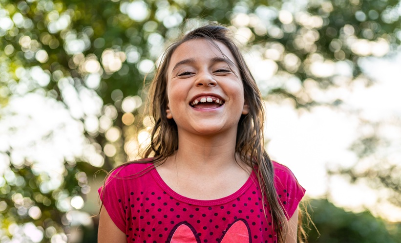Child outdoors in sunlight representing vitamin D deficiency and pediatric health.