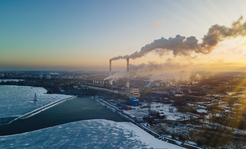 Emission to atmosphere from industrial pipes. Smokestack pipes shooted at sunrise. Global warming concept and air pollution