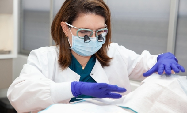 Dermatologist performing a noninvasive skin assessment for atopic dermatitis biomarkers.