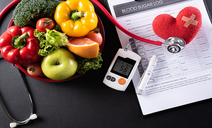blood sugar moniter surrounded by vegetables