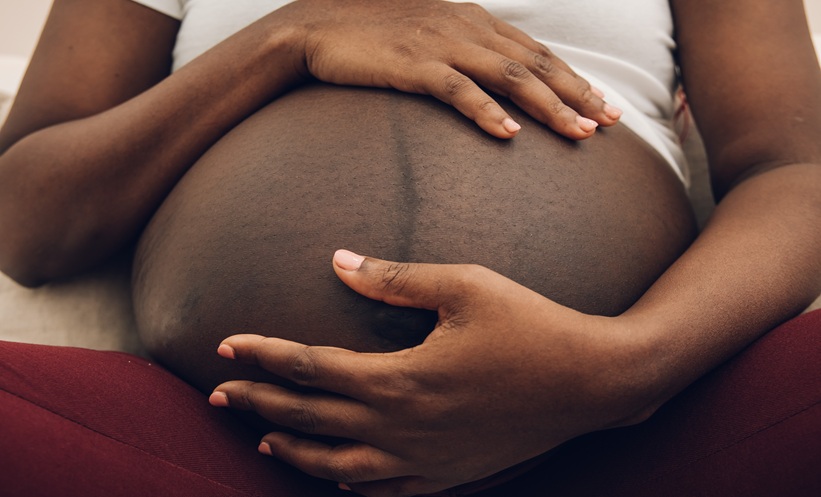 Woman holding her pregnant belly