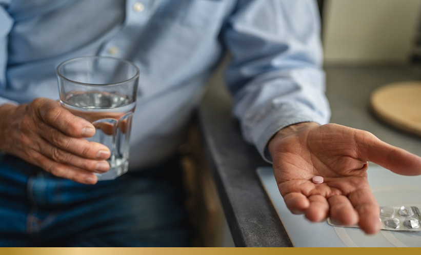 Man holding pills