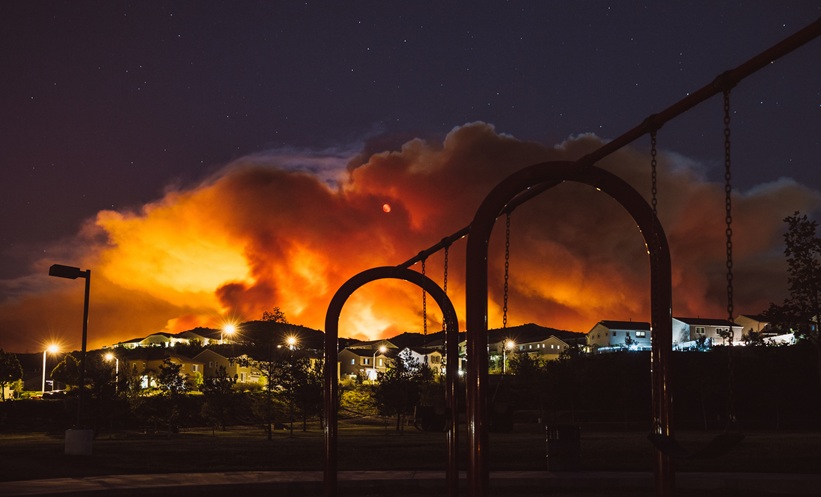 Wildfire smoke covering a city and increasing exposure to harmful fine particulate air pollution.