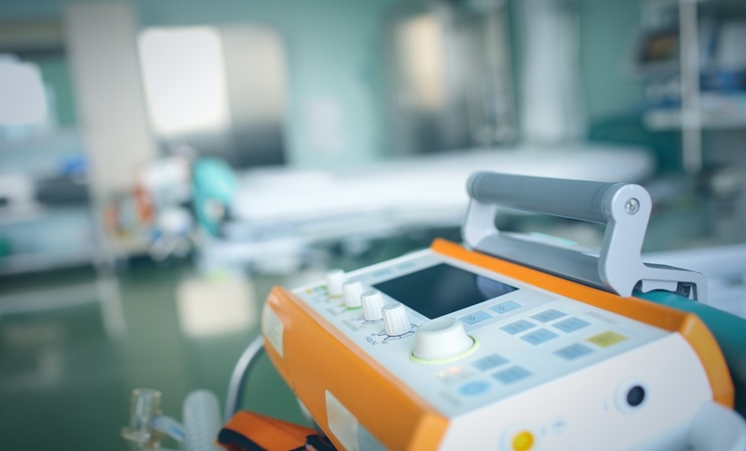 Nurse assisting an ICU patient with repositioning as part of pressure injury prevention.