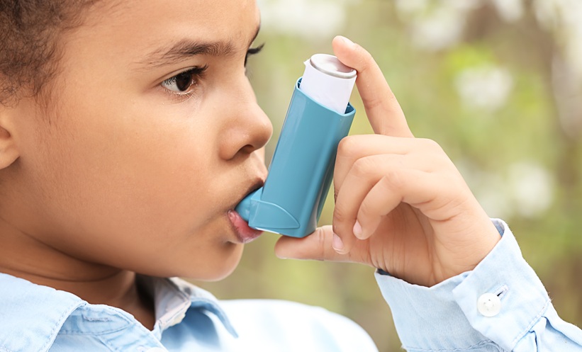 child holding asthma inhaler
