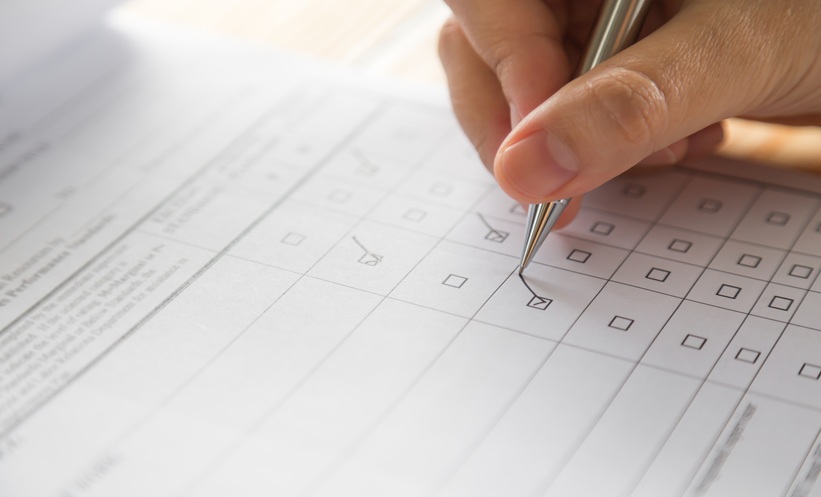 Person checking box on questionnaire