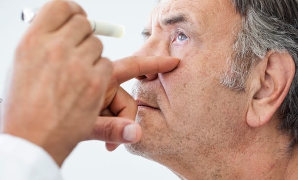 Old man getting his eyes looked in by an ophthalmologist