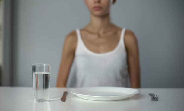 Person with empty plate in front of them