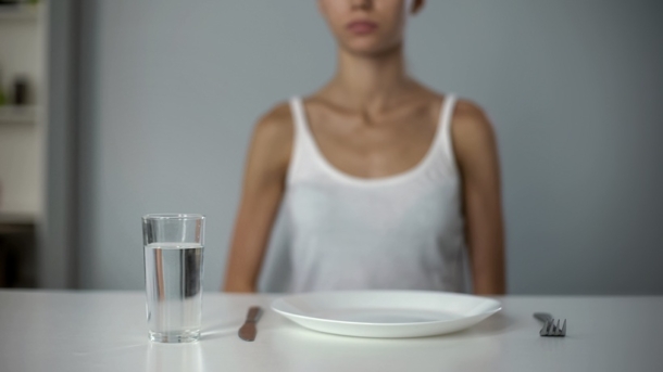 Person with empty plate in front of them