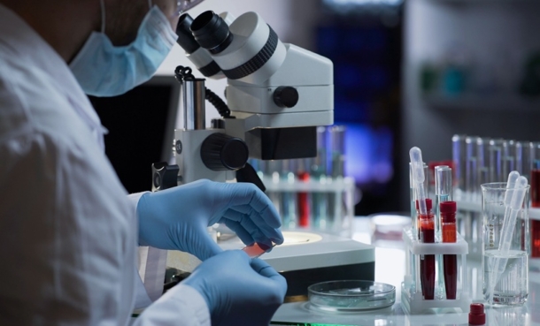 A person looking at a microscope