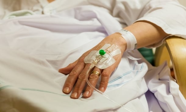 Hand of hospital patient with infusion going in