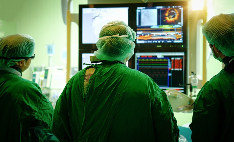 Surgeons look at coronary screen in cath lab