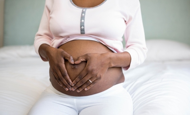 Woman holding her pregnant belly