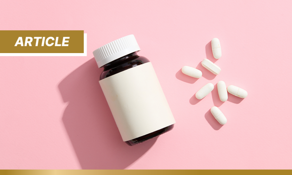 An unlabeled medicine bottle, accompanied by several white pills on a pink background