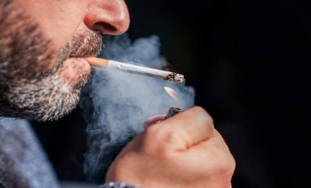 Person lighting up a cigerette close up