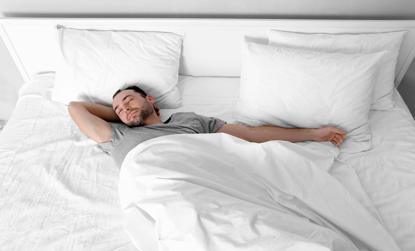 Adult man sleeping in bed, illustrating obstructive sleep apnea and emerging treatments such as retatrutide.