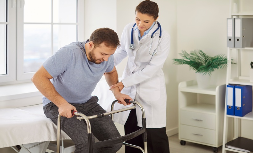 youg man learning to walk again after stroke