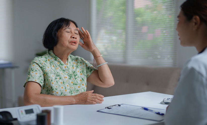 Older Asian American woman speaking with a care team member about lung cancer screening