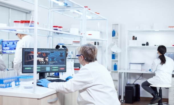 Researchers analyzing data in a laboratory studying targeted therapies for pemphigus vulgaris.