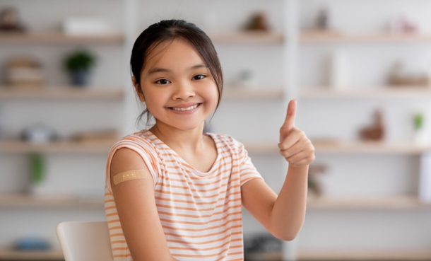 Cute korean girl got vaccinated, showing band and thumb up