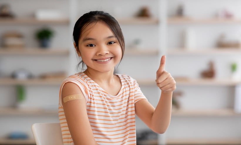 Cute korean girl got vaccinated, showing band and thumb up