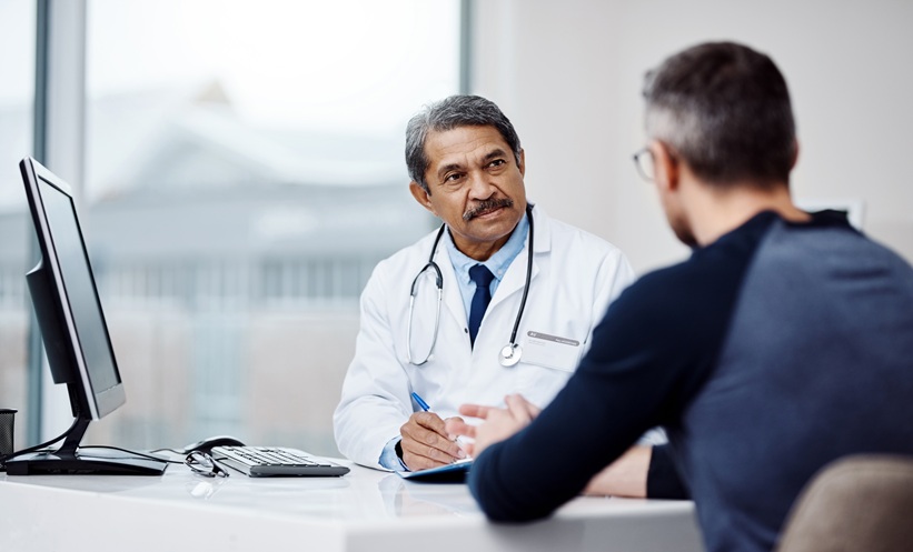 Physician discussing pulmonary tuberculosis treatment options with an adult patient during a consultation.