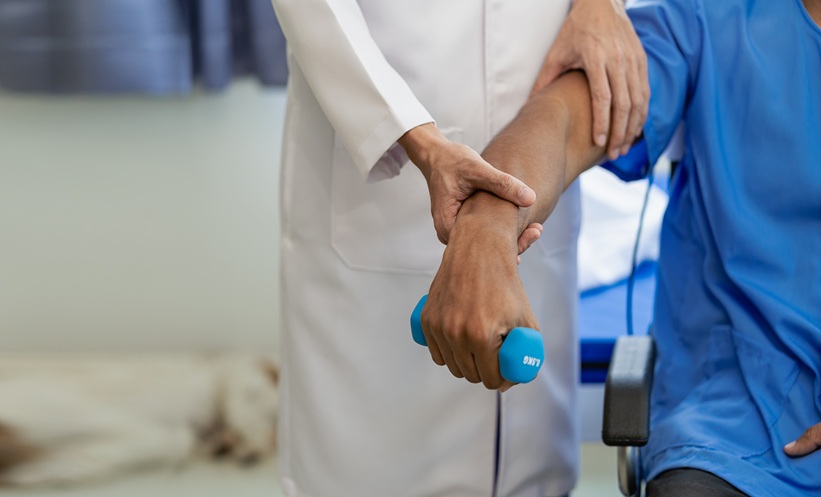 Physiotherapist treating hospital patient and shoulder pain Physiotherapy specialists help patients in physiotherapy . about muscle weakness and fatigue.