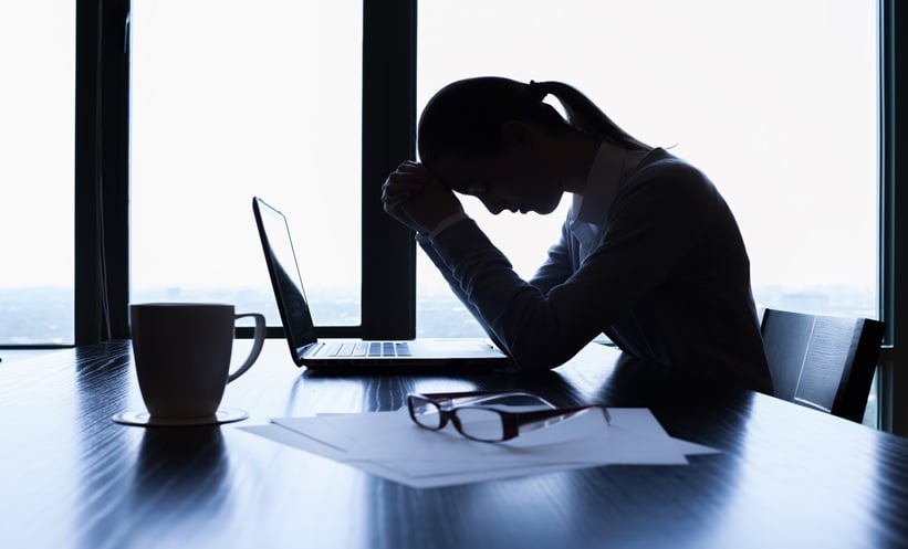 stressed business woman with her head down