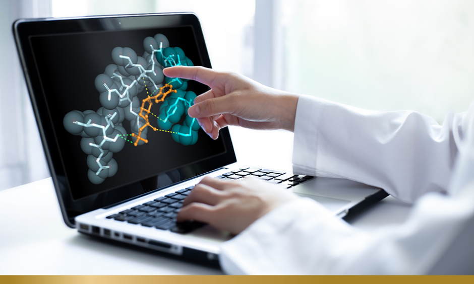 Closeup of researcher hand pointing at a laptop screen displaying 3D molecular model.