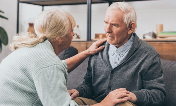 Elderly person with dementia or Alzheimer's disease is being comforted by another woman