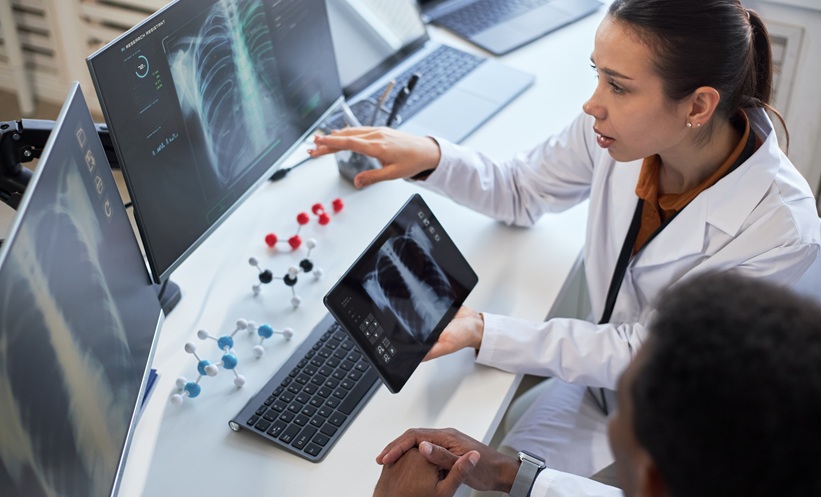 Radiologist looking at a computer scans on it with scans on it