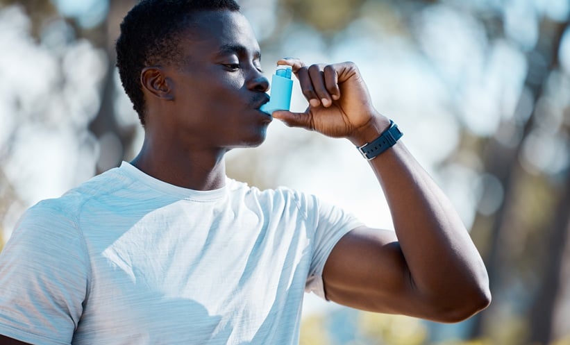 a person using an inhaler