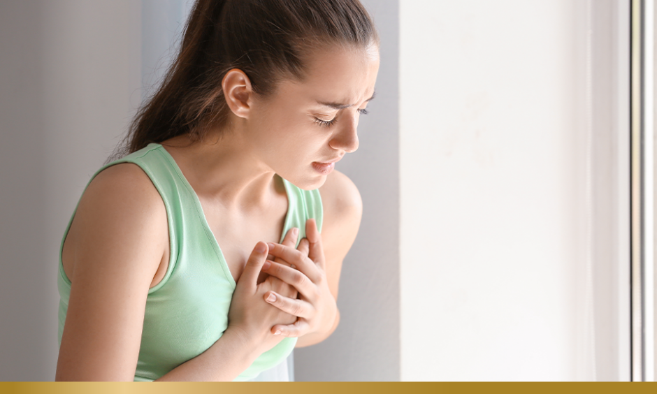 Young woman suffering from heart attack at home