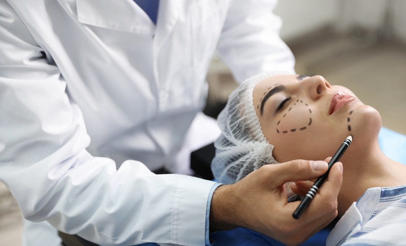 Person getting cosmetic procedures and surgery as regulation to be enforced in the UK