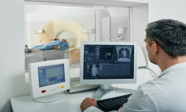 A doctor looking at an MRI patient
